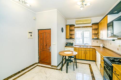 a kitchen with a table and a wooden door at Azneft Royal Suite Apartment Sea View in Baku