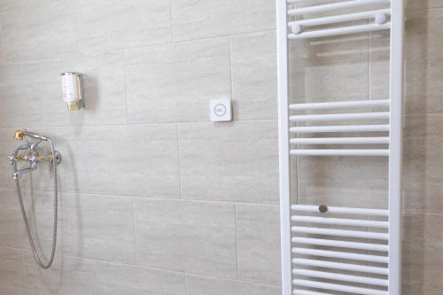 a shower with a glass door in a bathroom at Hotel Domenic FREE PARKING in Plovdiv