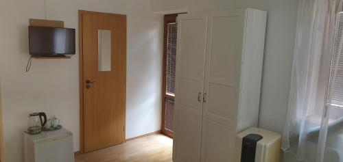 a room with a closet and a door with a television at Radio Hotel Bratislava in Trnávka