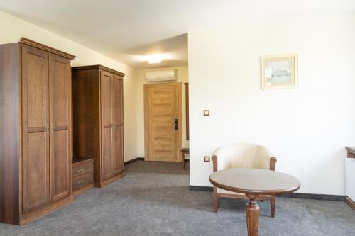 a room with a table and a cabinet at Hotel Domenic FREE PARKING in Plovdiv