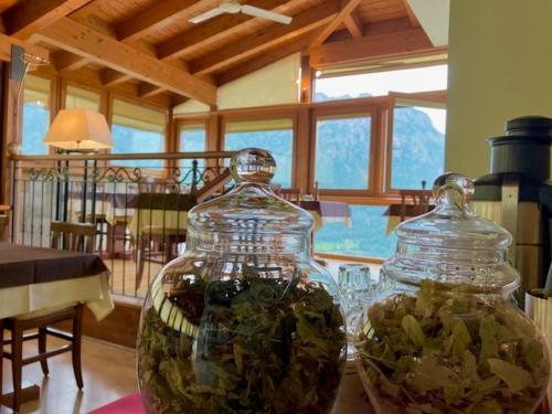 a glass jar filled with plants on top of a table at Da Gigi Alpine Rooms in Crandola Valsassina