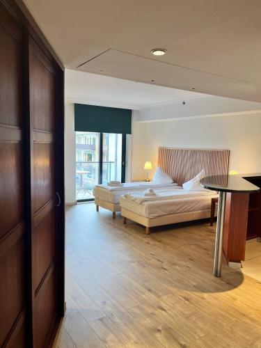 Ένα ή περισσότερα κρεβάτια σε δωμάτιο στο B-aparthotel Ambiorix