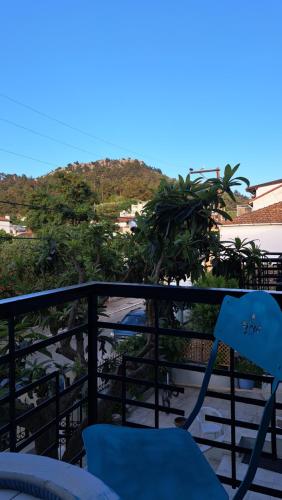 a blue chair sitting on top of a balcony at Bamboo deluxe in Limenas