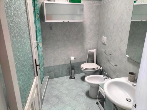 a bathroom with a toilet and a sink at Casa Franca in Ischia