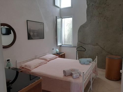 a bedroom with a bed with towels on it at Casa Franca in Ischia