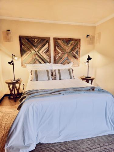 a bedroom with a large white bed with two lamps at Casa da Fidalga in Outeiro de Gatos