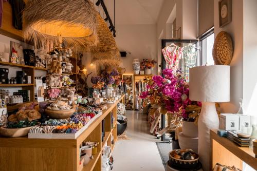 a store filled with lots of flowers and other items at Strandhotel in Cadzand-Bad
