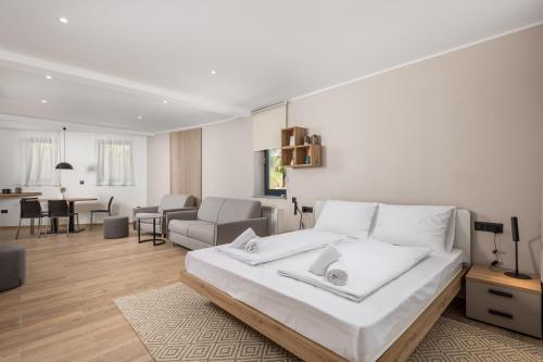 a bedroom with a large bed and a living room at Belinda apartments with balcony in Opatija