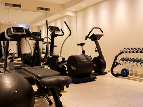 a gym with several exercise bikes in a room at SeeHuus Lifestyle Hotel in Timmendorfer Strand