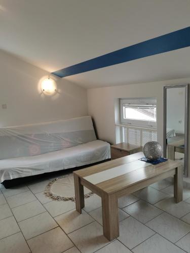 a living room with a bed and a table at Apartments Riva Povljana in Povljana