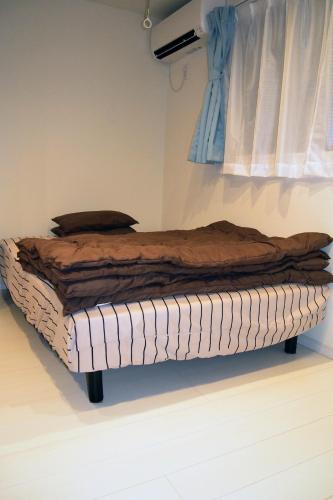a bed is sitting in a room with at The FLAT 103 in Tokyo