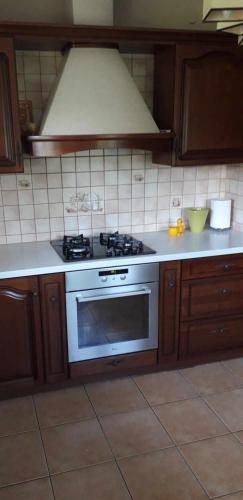 a kitchen with a white stove top oven at Zajazd Stok in Górecko Stare