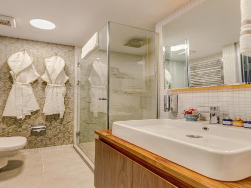a bathroom with a white sink and a shower at Sometimes Hotel Taksim in Istanbul