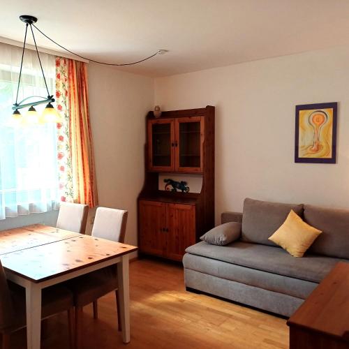 a living room with a couch and a table at Naturhaus Andrea in Grossarl