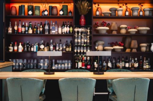 a bar with chairs in front of a table at A-ROSA Sylt in List