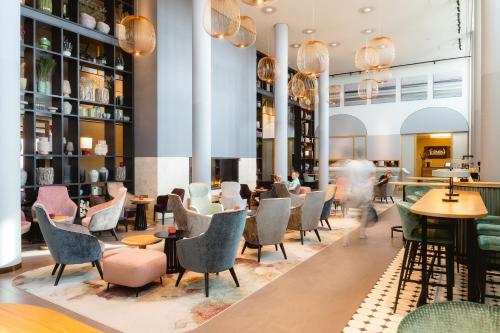 a restaurant with chairs and tables in a lobby at A-ROSA Sylt in List