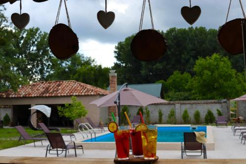 a table with some drinks on it next to a pool at Zhebota garden Tianeti in Zhebota