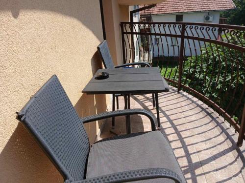 a patio with two chairs and a table on a balcony at Provence rooms in Banja Luka