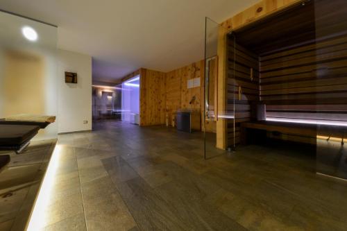 a large room with a bench and wooden walls at Mountainlodge Luxalpine in San Vigilio Di Marebbe