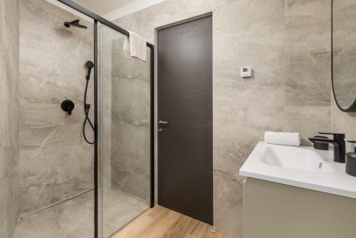 a bathroom with a shower and a sink at Belinda apartments with balcony in Opatija