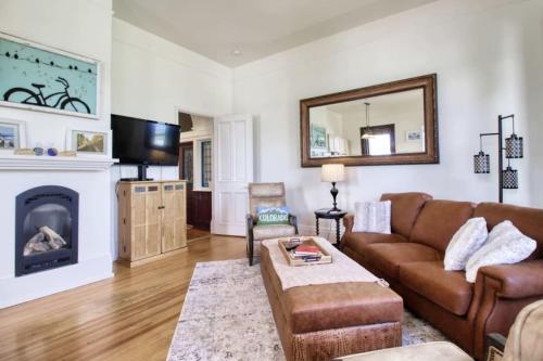 a living room with a couch and a fireplace at Historic Mountain Loft with GREAT Views in Leadville