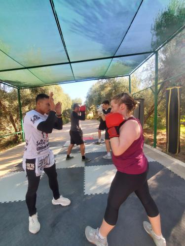 a man and a woman standing in front of a mirror at Koom Martial Arts Retreat & Training Center Marrakech Morocco in Had Abdallah Rhiat