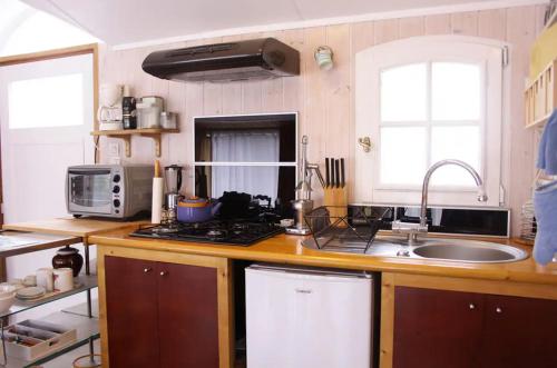 a kitchen with a sink and a counter top at Charmante Péniche - Séjour atypique Nantes in Nantes