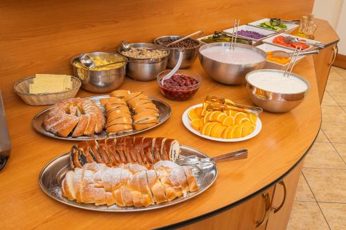 a table with many plates of food on it at City Centre in Prague