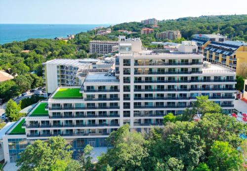 an aerial view of a large white building at Poseidon Beach Resort - Premium All Inclusive & Free Riviera Beach Access in Golden Sands