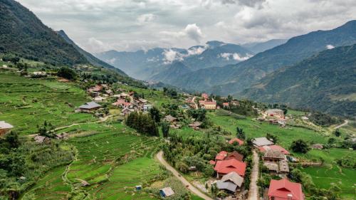 an aerial view of a village in a valley with mountains at Muong Hoa Eco Villa in Sa Pa