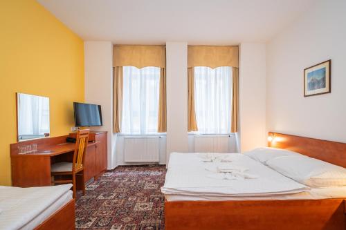Postel nebo postele na pokoji v ubytování City Central De Luxe