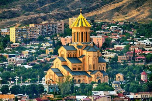 a church with a tower on top of a city at Tbilisi Center Hotel in Tbilisi City