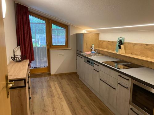 an empty kitchen with a sink and a window at apart STURPEN in Sankt Leonhard im Pitztal