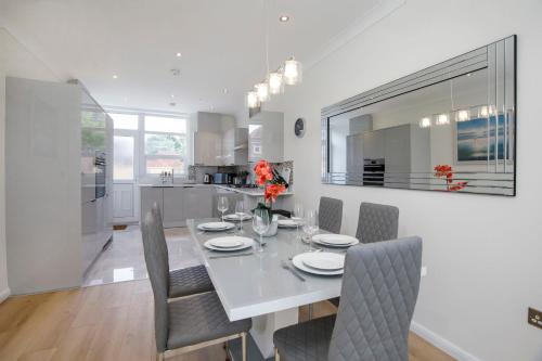 a white dining room with a white table and chairs at The Burton York 3 bedroom House sleeps 6 in York