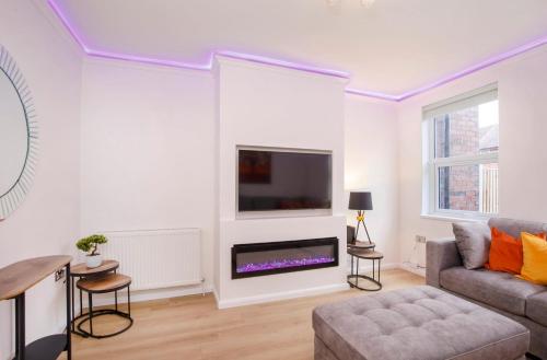 a living room with a couch and a tv at The Burton York 3 bedroom House sleeps 6 in York