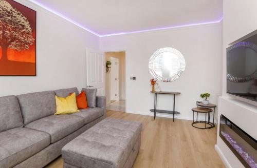 a living room with a couch and a television at The Burton York 3 bedroom House sleeps 6 in York