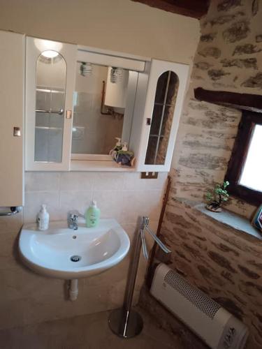 a bathroom with a sink and a mirror at Casa delle Rose - Marmora in Marmora