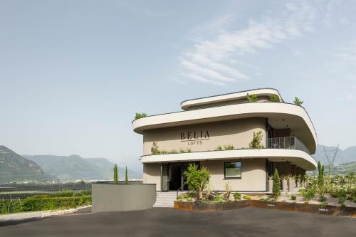 a building with a lot of plants in front of it at Belia Lofts - ADULTS ONLY - Apartments in Appiano sulla Strada del Vino