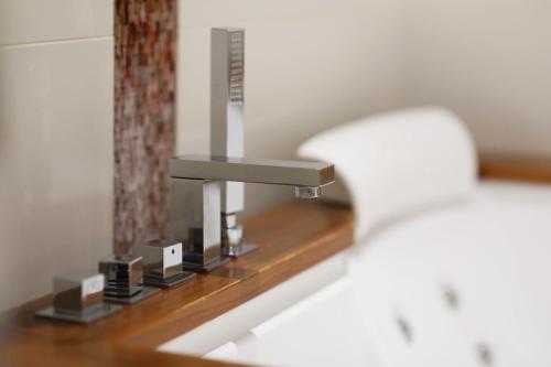 a close up of a bathroom sink with a faucet at Boutique Hotel Calzavecchio in Casalecchio di Reno