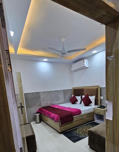 a bedroom with a bed with red pillows at Hotel Sheeri Inn in Faizābād