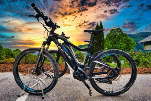a bike is parked in front of a sunset at Landhaus Ramsau in Ramsau am Dachstein