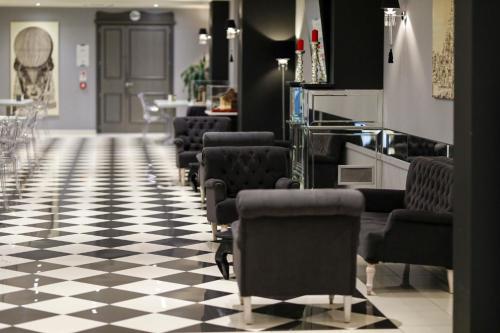 a salon with a row of chairs on a checkered floor at Boutique Hotel Calzavecchio in Casalecchio di Reno