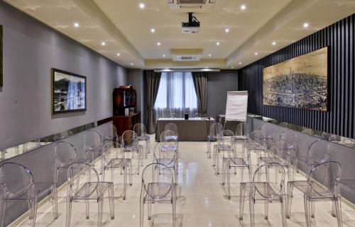 a conference room with chairs and a podium in the middle at Boutique Hotel Calzavecchio in Casalecchio di Reno