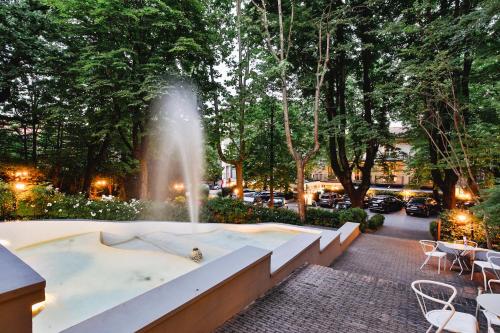 a fountain in the middle of a park at Boutique Hotel Calzavecchio in Casalecchio di Reno