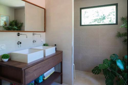 a bathroom with a white sink and a mirror at Maison familiale avec piscine in Aix-en-Provence