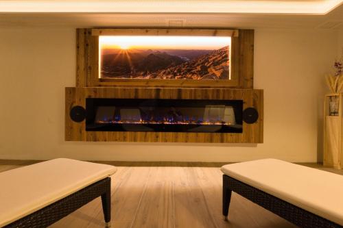 a living room with a fire place in a wall at Landhaus Ramsau in Ramsau am Dachstein