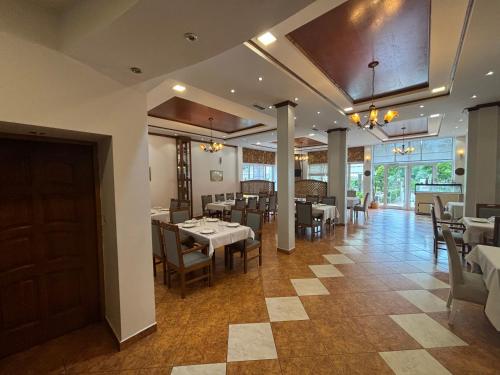 a dining room with tables and chairs in a restaurant at Hotel Restorant Halal Il Tramonto. in Vorë