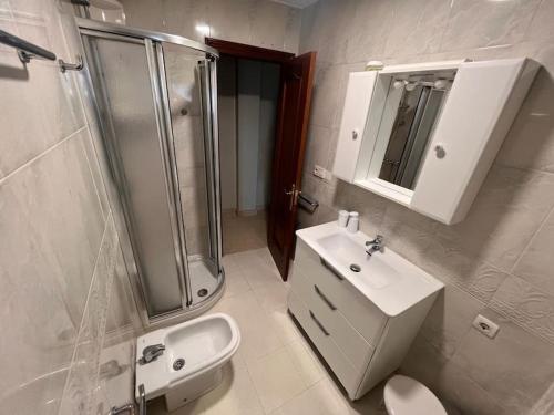 a bathroom with a shower and a sink and a toilet at Villa Marie in Betanzos
