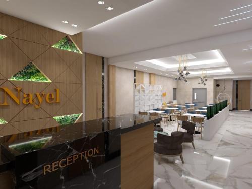 a lobby of a restaurant with tables and chairs at Nayel Hotel in Durrës