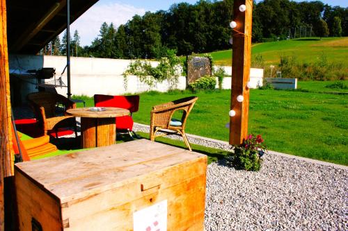 a patio with a wooden table and chairs and a table at Nisihof, Landluft in Oberkirch